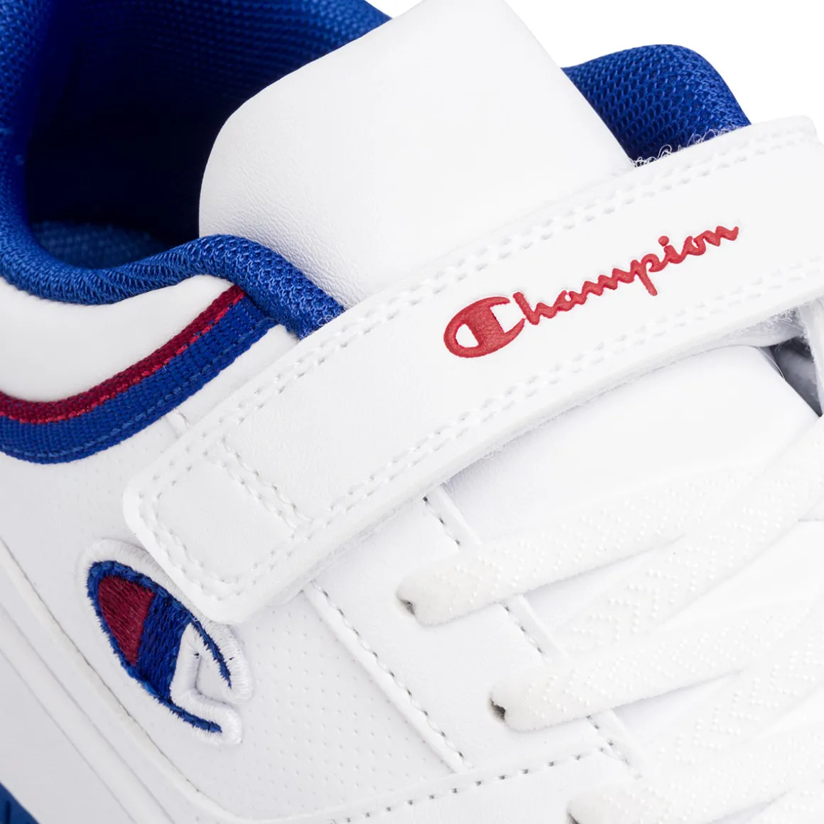 Sneakers da ragazzo bianche cobn dettagli blu e rossi Champion Rebound Low